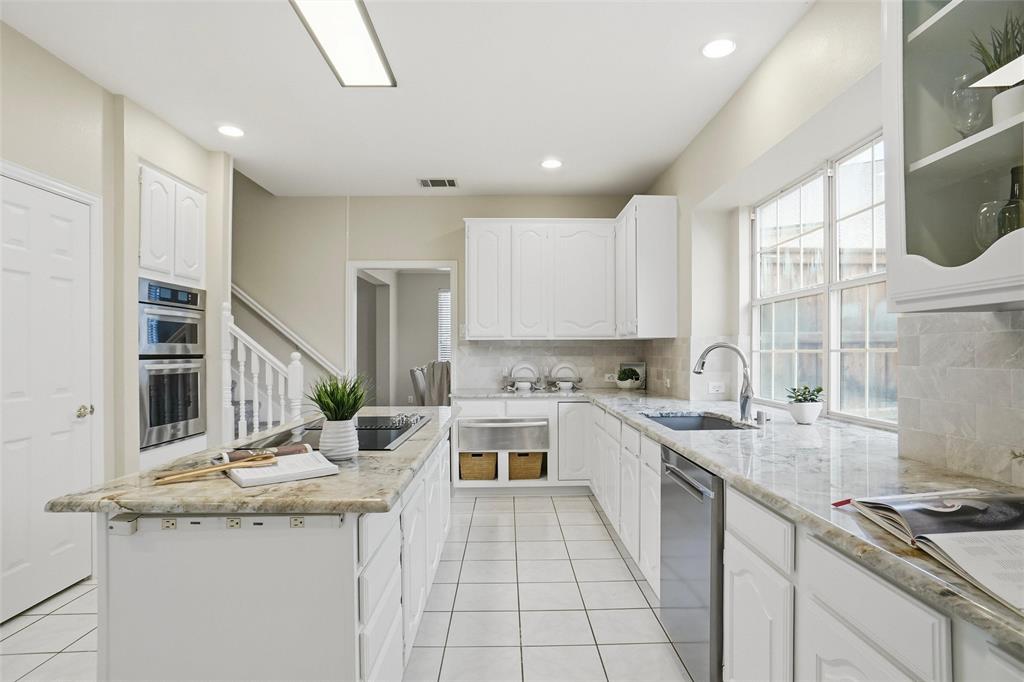 132 Rustic Meadow Way Coppell, TX 75019 - Photo 13 of 39 a kitchen with a sink stove and cabinets