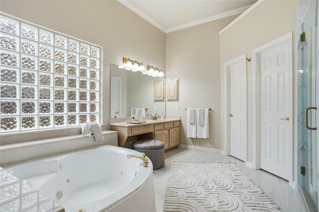 132 Rustic Meadow Way Coppell, TX 75019 - Photo 18 of 39 a bathroom with a tub sink and a mirror