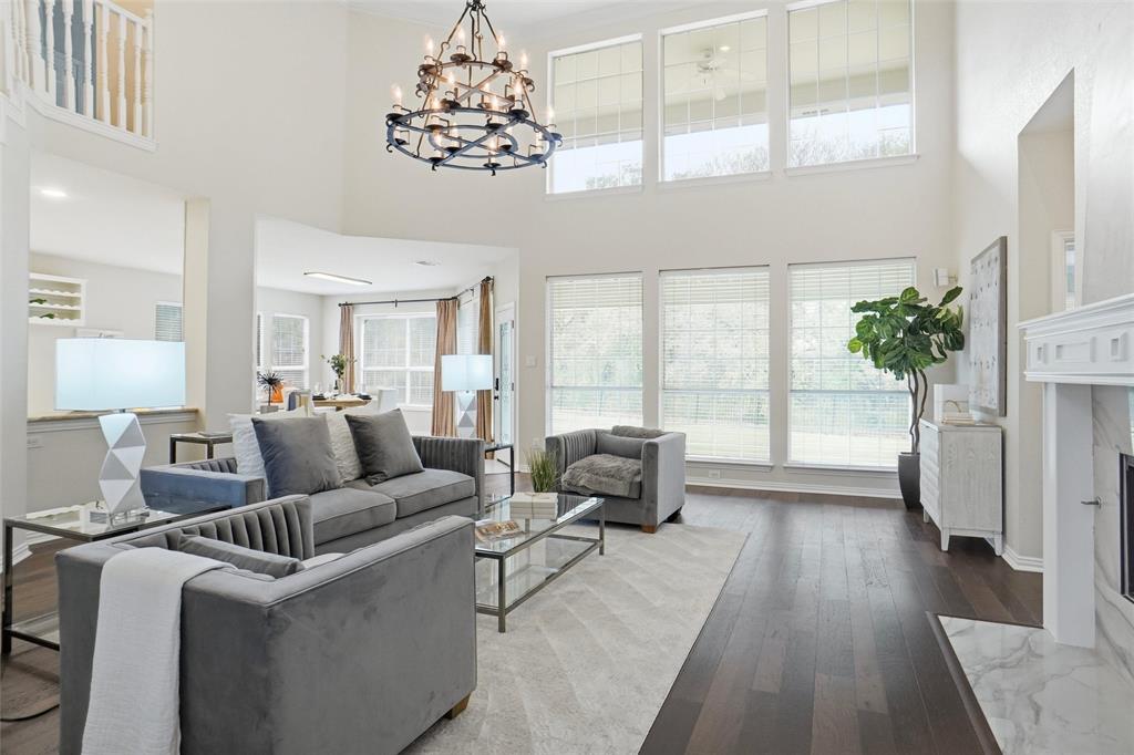 132 Rustic Meadow Way Coppell, TX 75019 - Photo 8 of 39 a living room with furniture and a chandelier