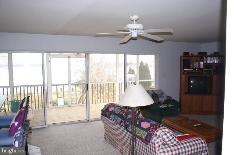 6608 River Drive Road Sparrows Point, MD 21219 - Photo 3 of 16 a living room with furniture and a floor to ceiling window