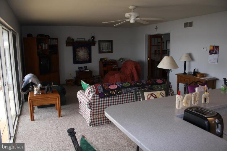 6608 River Drive Road Sparrows Point, MD 21219 - Photo 4 of 16 a living room with furniture and a lamp