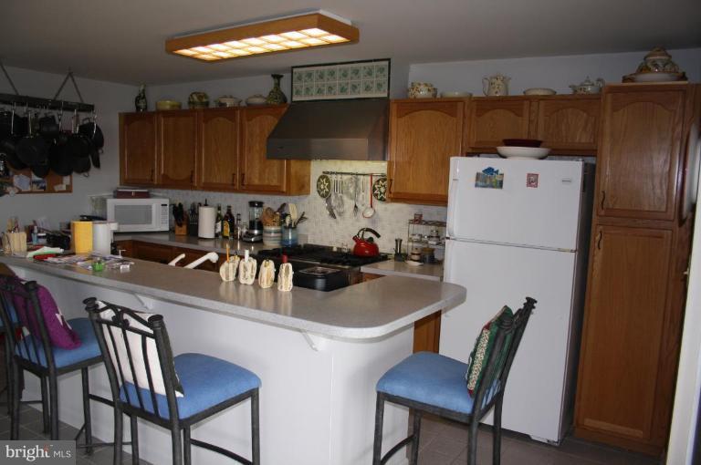 6608 River Drive Road Sparrows Point, MD 21219 - Photo 6 of 16 a kitchen with a dining table and chairs