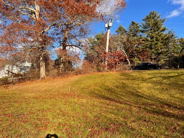 a view of a yard next to a house with lake view