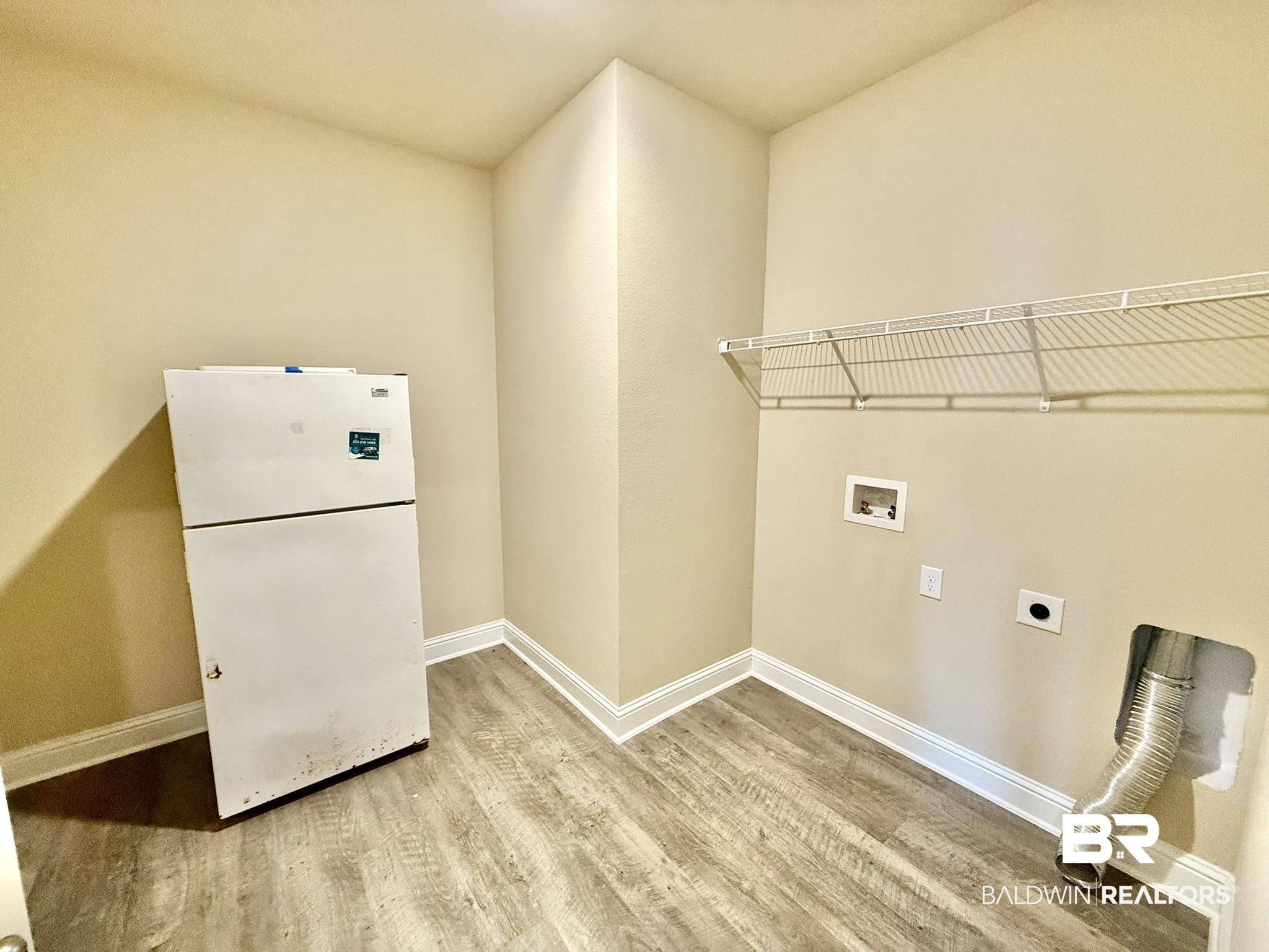 8648 Calverton Street Foley, AL 36535 - Photo 31 of 45 Laundry room with hookup for an electric dryer, wood finished floors, and hookup for a washing machine