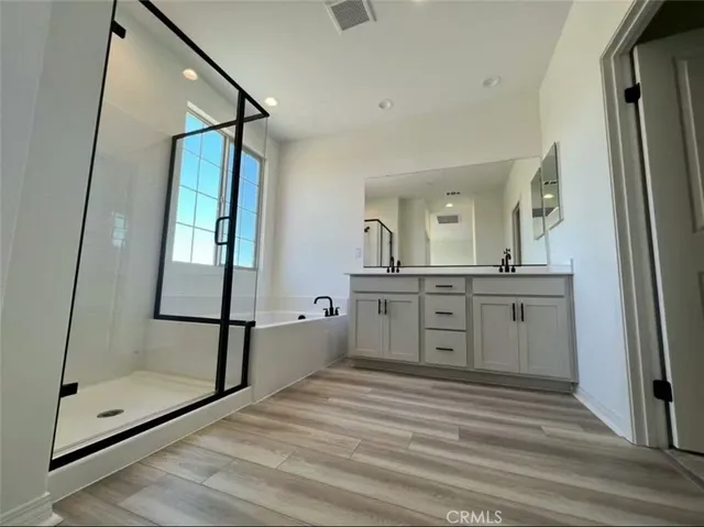 a bathroom with a sink a mirror and a shower