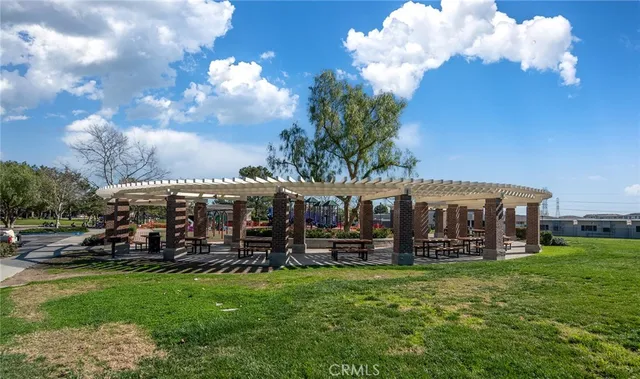 a view of a patio with a table and chairs and potted plants