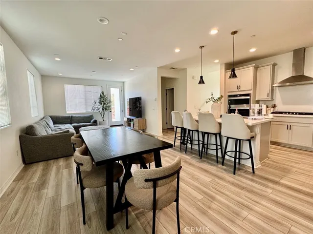 a large kitchen with a table and chairs