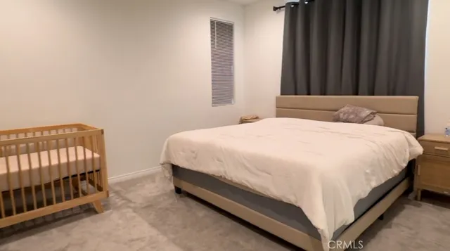 a bed sitting in a bedroom next to a window