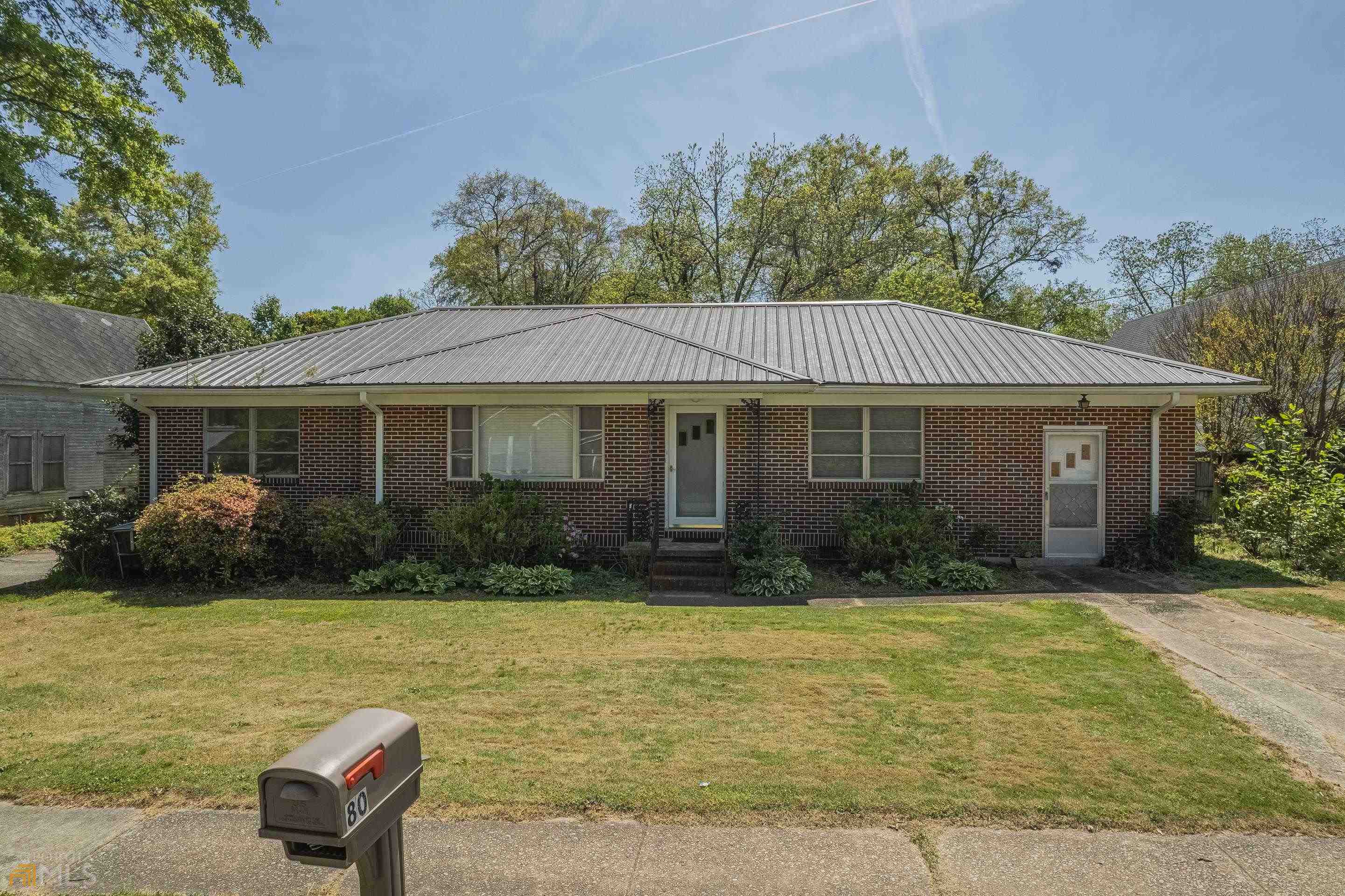 80 Old Elbert Road Royston, GA 30662 - Photo 1 of 1 a front view of a house with a garden and patio
