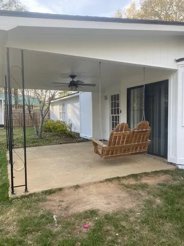 a view of a livingroom with furniture and floor to ceiling window
