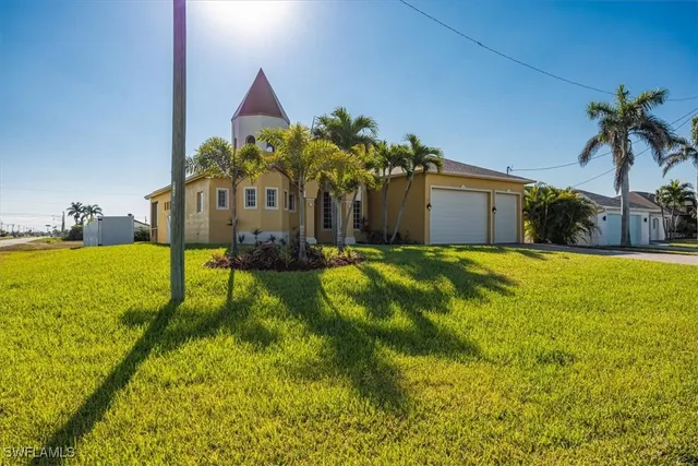a view of a house with a yard and potted plants