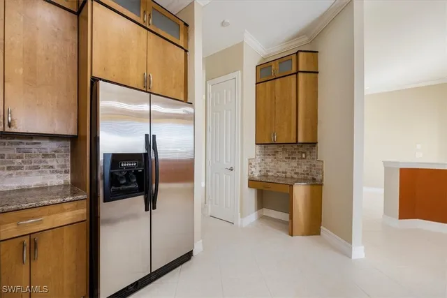 a kitchen with stainless steel appliances granite countertop a refrigerator and a stove