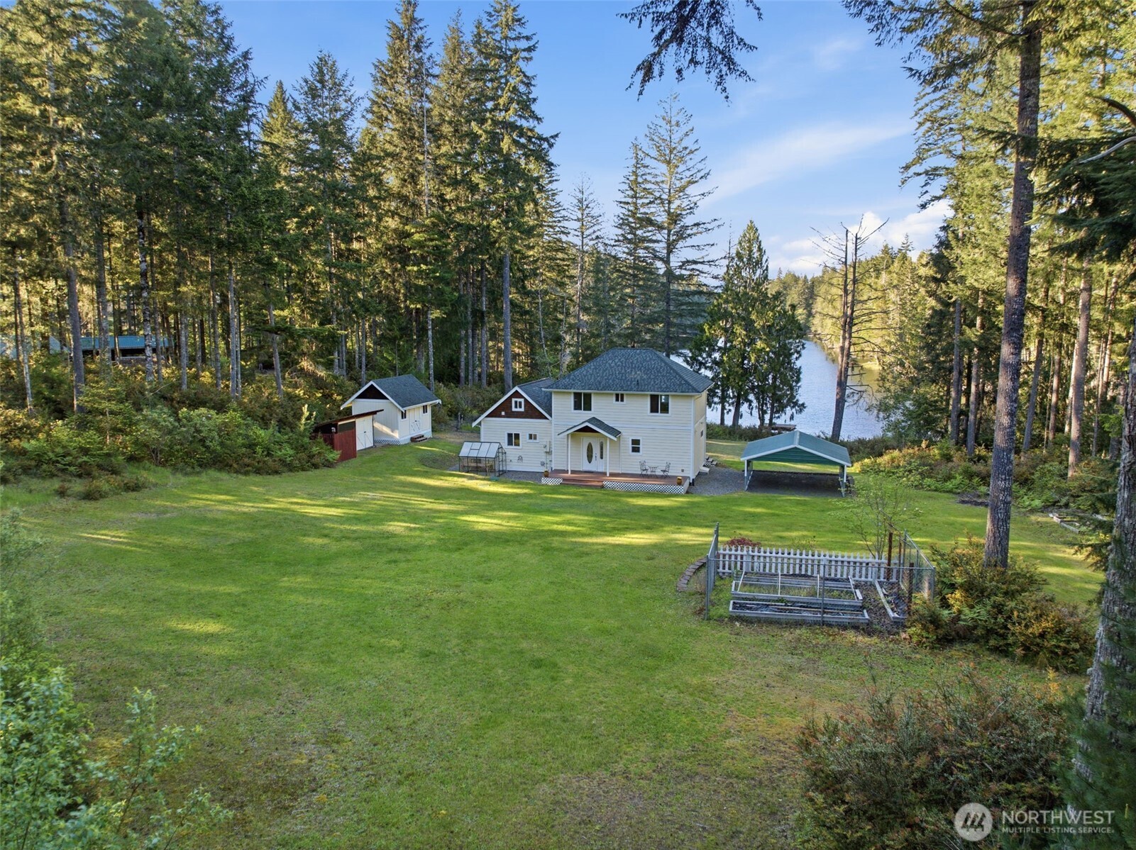 6971 Northeast Tahuya Blacksmith Road Belfair, WA 98528 - Photo 36 of 38 a view of a house with a yard and sitting area