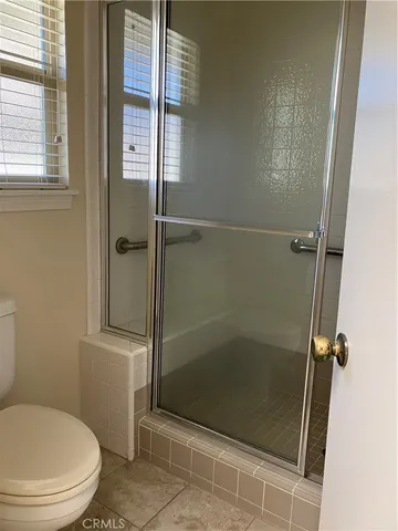 a bathroom with a shower and a toilet