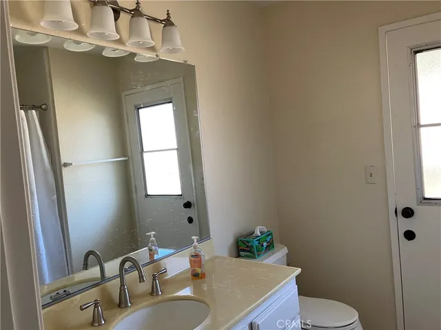 a bathroom with a sink toilet and mirror