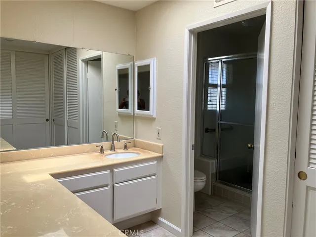 a bathroom with a tub sink and shower