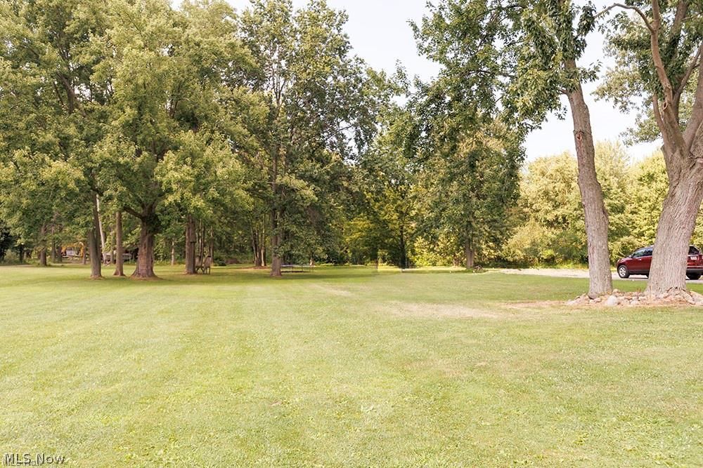 32618 Detroit Road Avon, OH 44011 - Photo 8 of 40 Expansive green lawn surrounded by mature trees