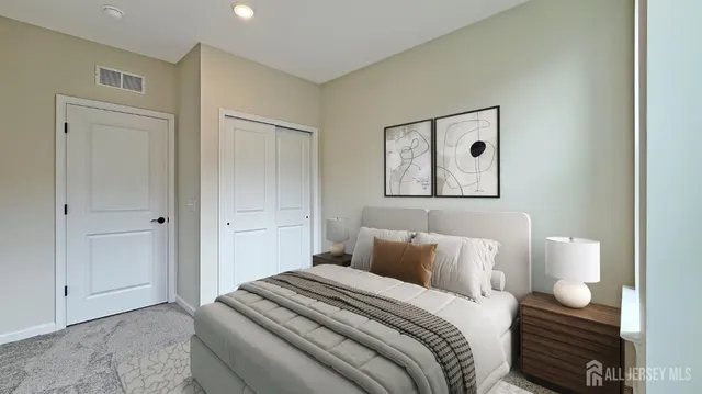 a bedroom with bed and cabinets