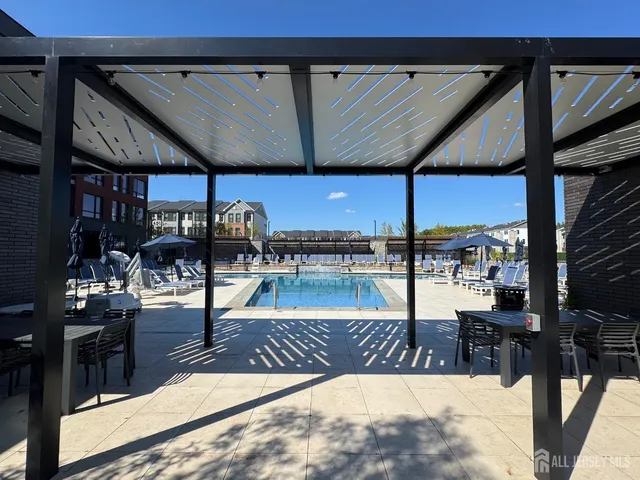 a view of a patio with a table and chairs