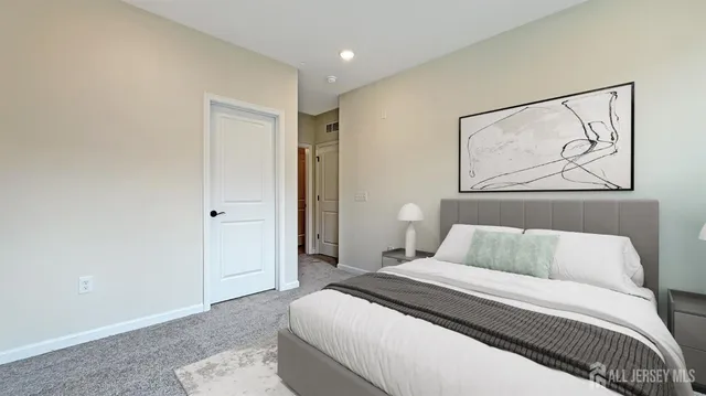 a bedroom with a bed and painting on the wall