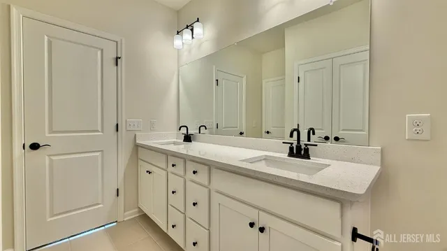 a bathroom with a double vanity sink and mirror