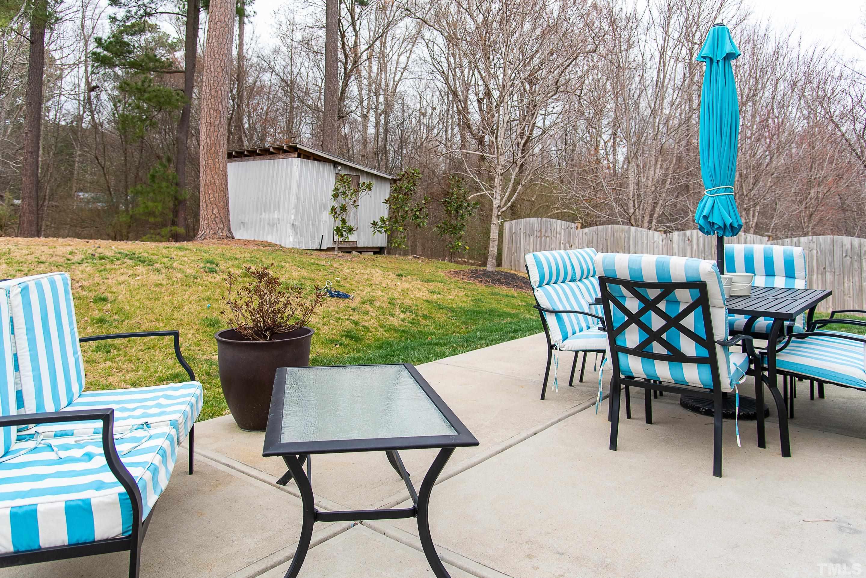 612 Hope Valley Road Knightdale, NC 27545 - Photo 15 of 56 a view of a patio with table and chairs with wooden fence and plants