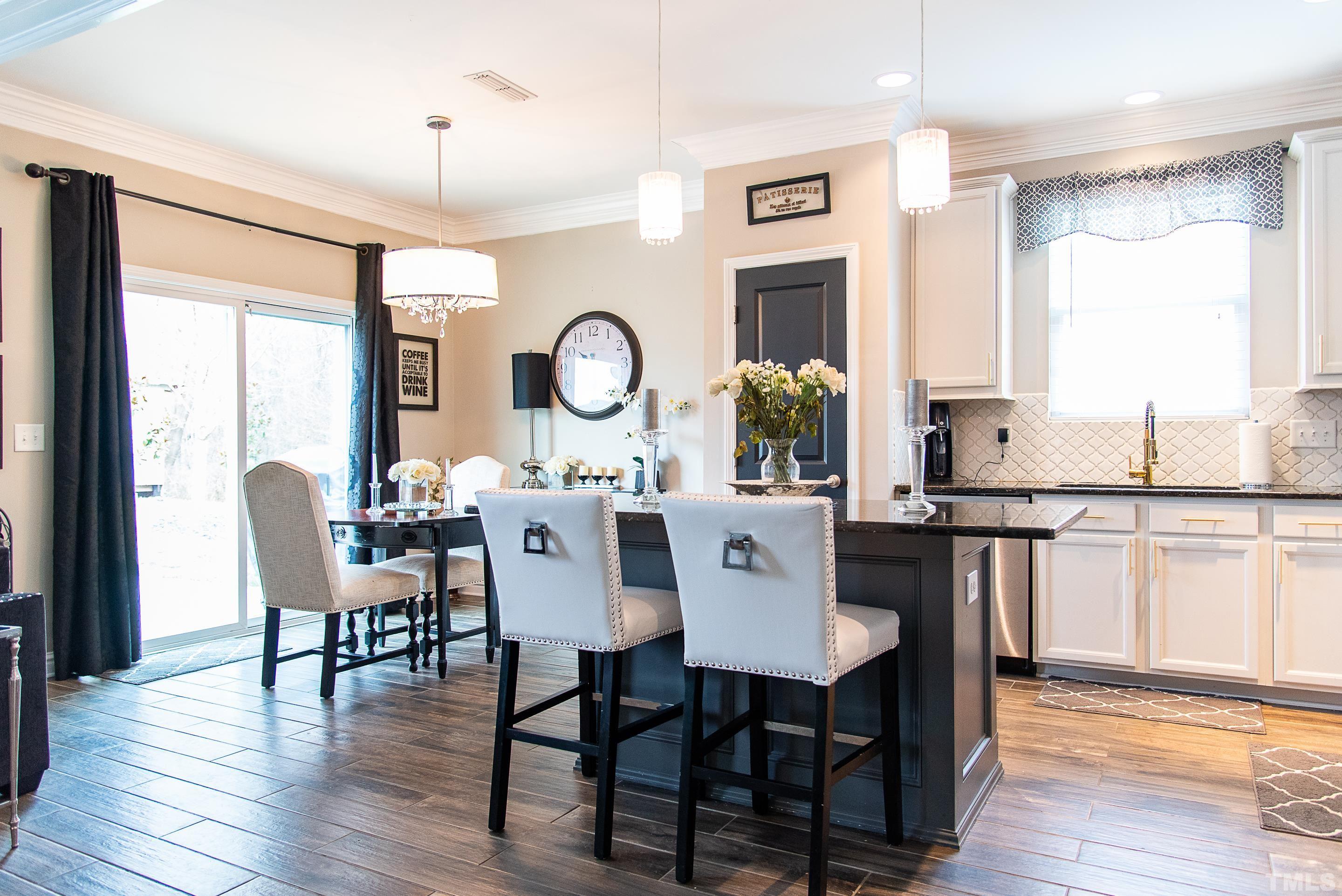 612 Hope Valley Road Knightdale, NC 27545 - Photo 19 of 56 a view of a dining room with furniture window and wooden floor