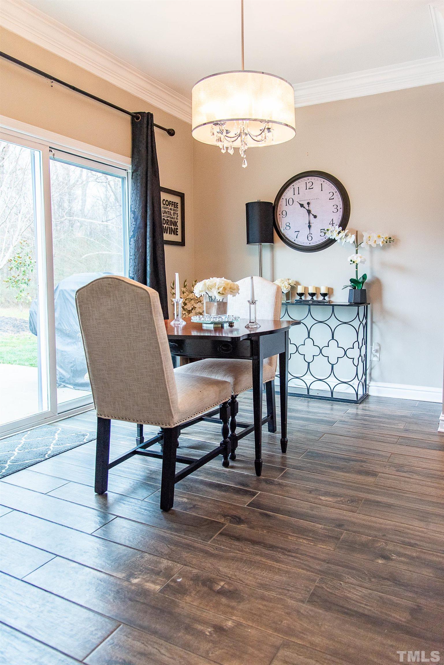 612 Hope Valley Road Knightdale, NC 27545 - Photo 21 of 56 a dining room with wooden floor a chandelier a wooden table and chairs