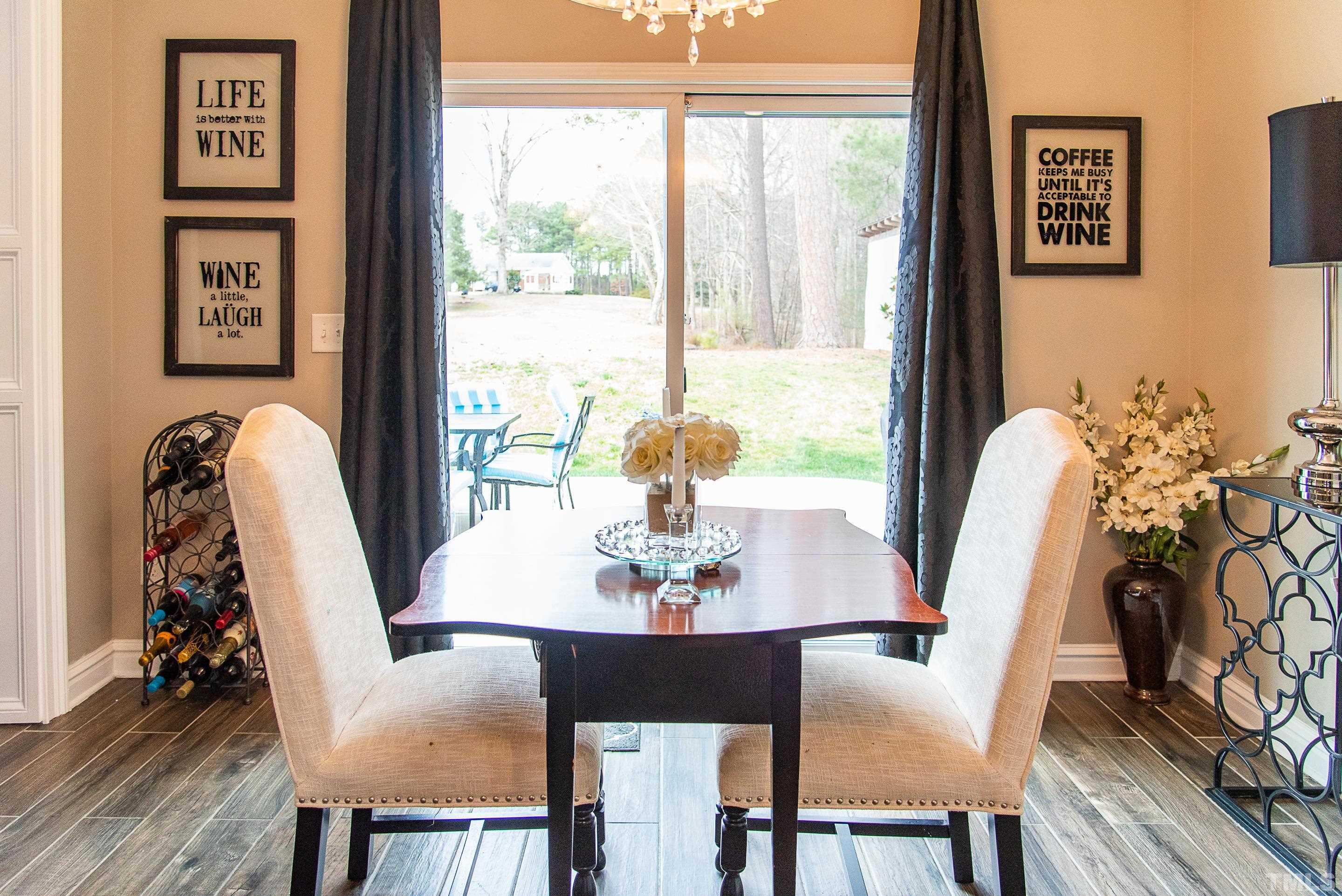 612 Hope Valley Road Knightdale, NC 27545 - Photo 22 of 56 a view of a dining room with furniture window and wooden floor