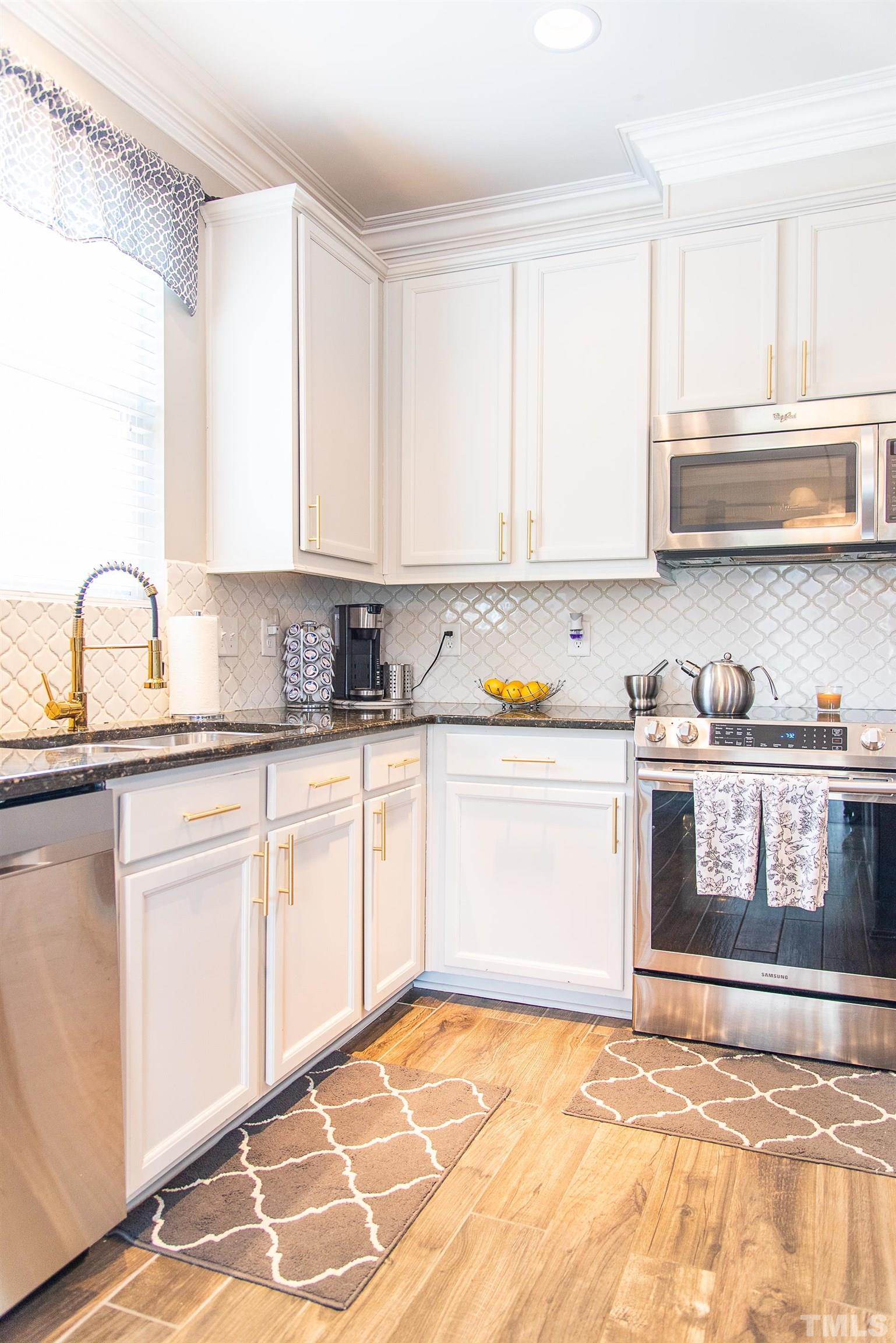 612 Hope Valley Road Knightdale, NC 27545 - Photo 23 of 56 a kitchen with granite countertop a sink cabinets and window