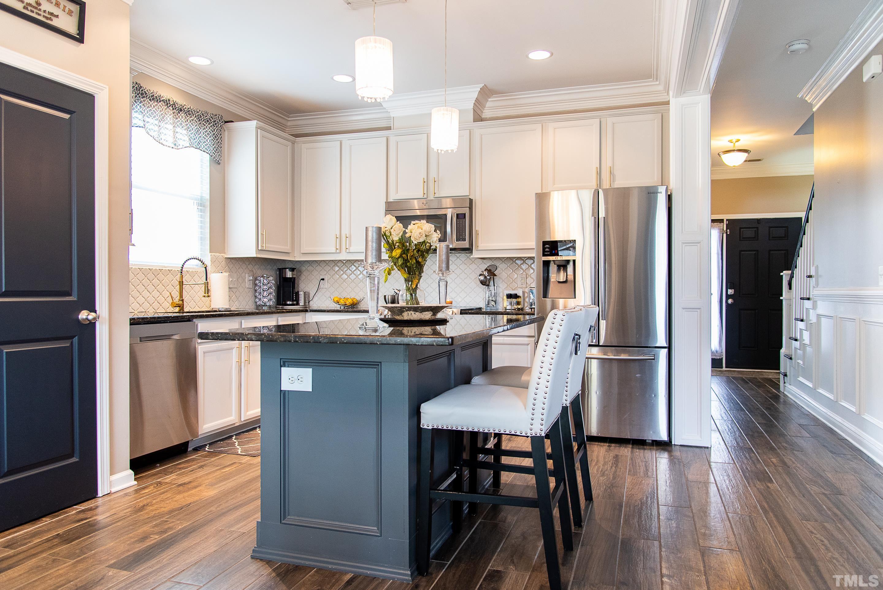 612 Hope Valley Road Knightdale, NC 27545 - Photo 24 of 56 a kitchen with stainless steel appliances a refrigerator sink and wooden floor