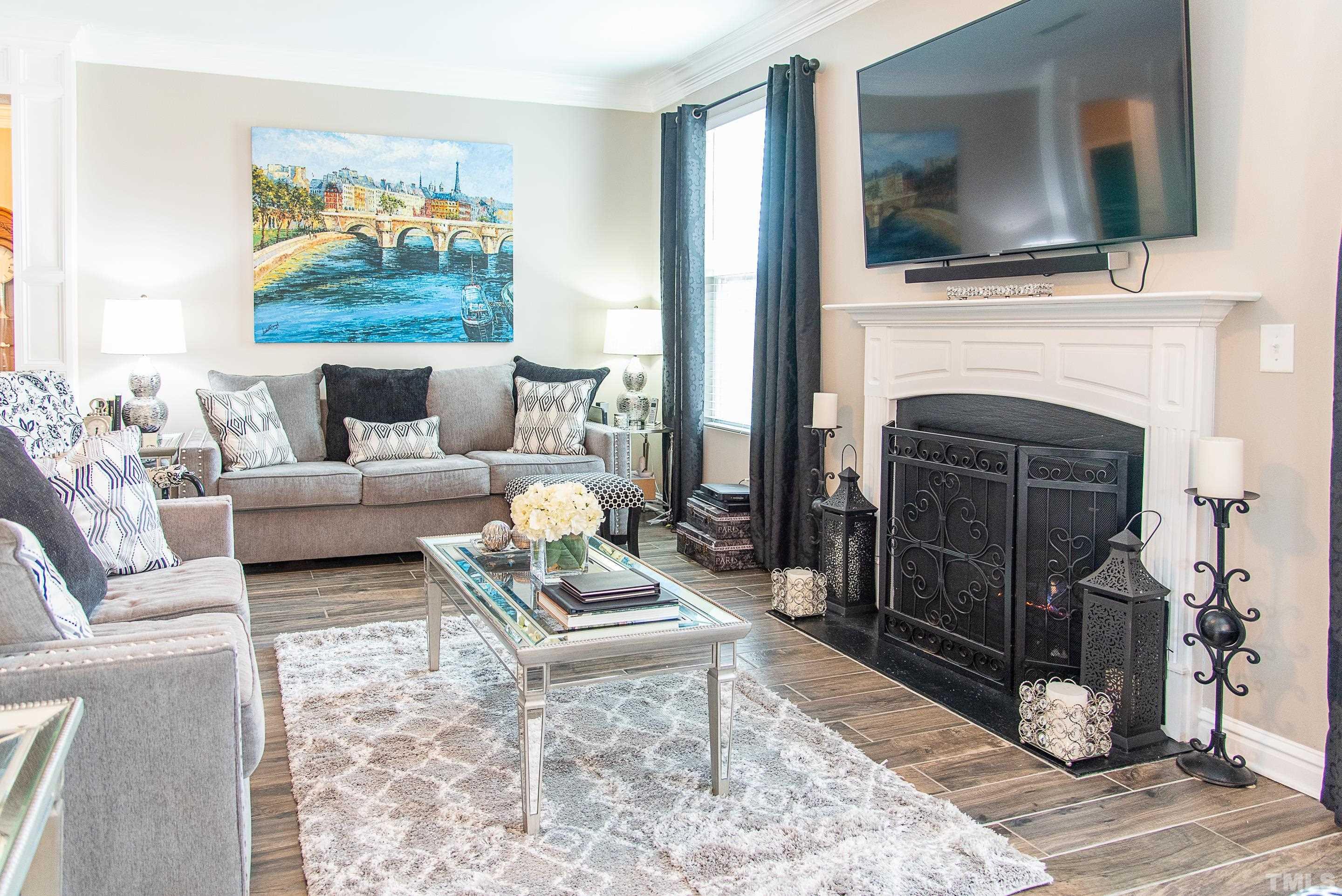 612 Hope Valley Road Knightdale, NC 27545 - Photo 26 of 56 a living room with furniture a flat screen tv and a fireplace