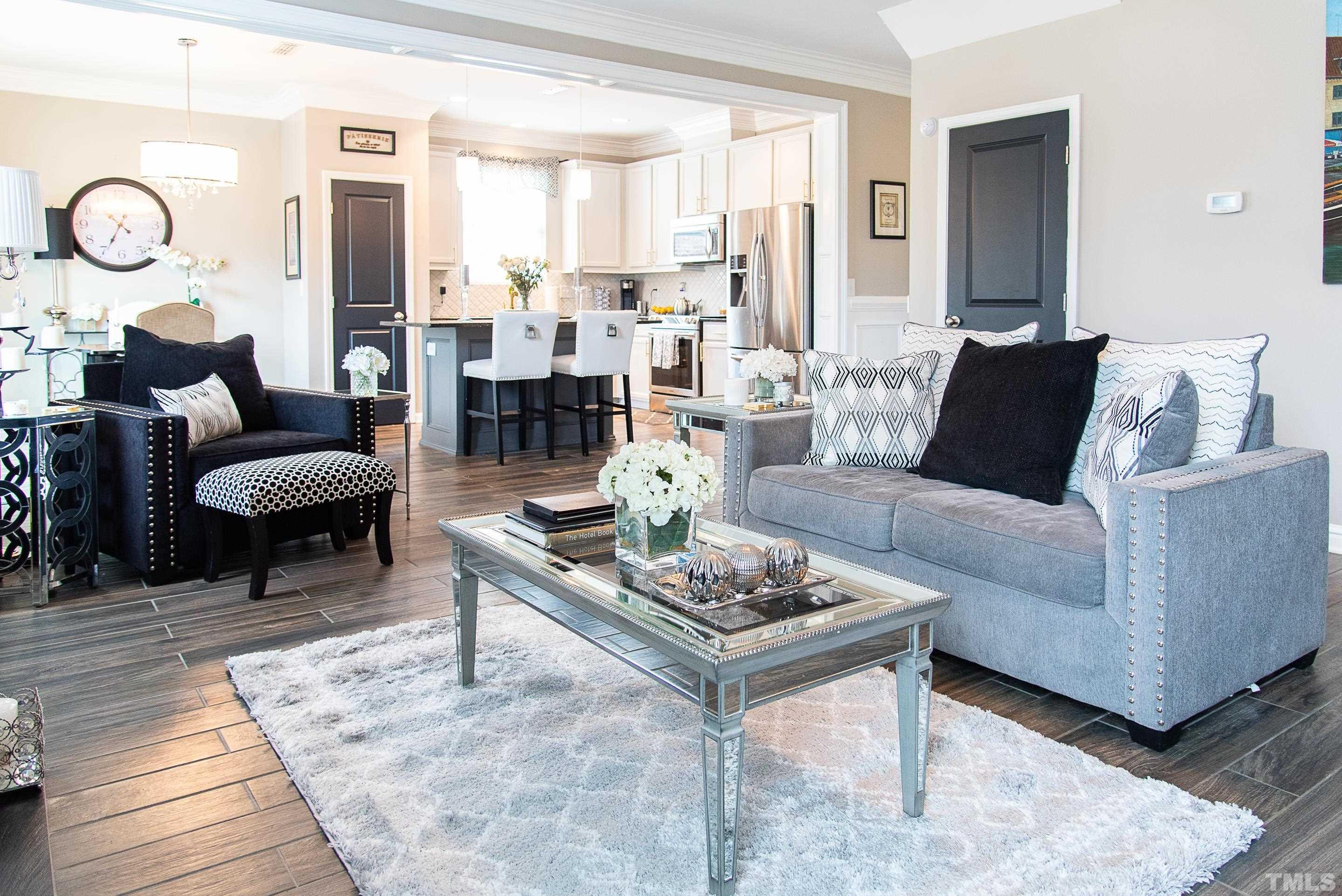 612 Hope Valley Road Knightdale, NC 27545 - Photo 29 of 56 a living room with furniture a rug and a large window