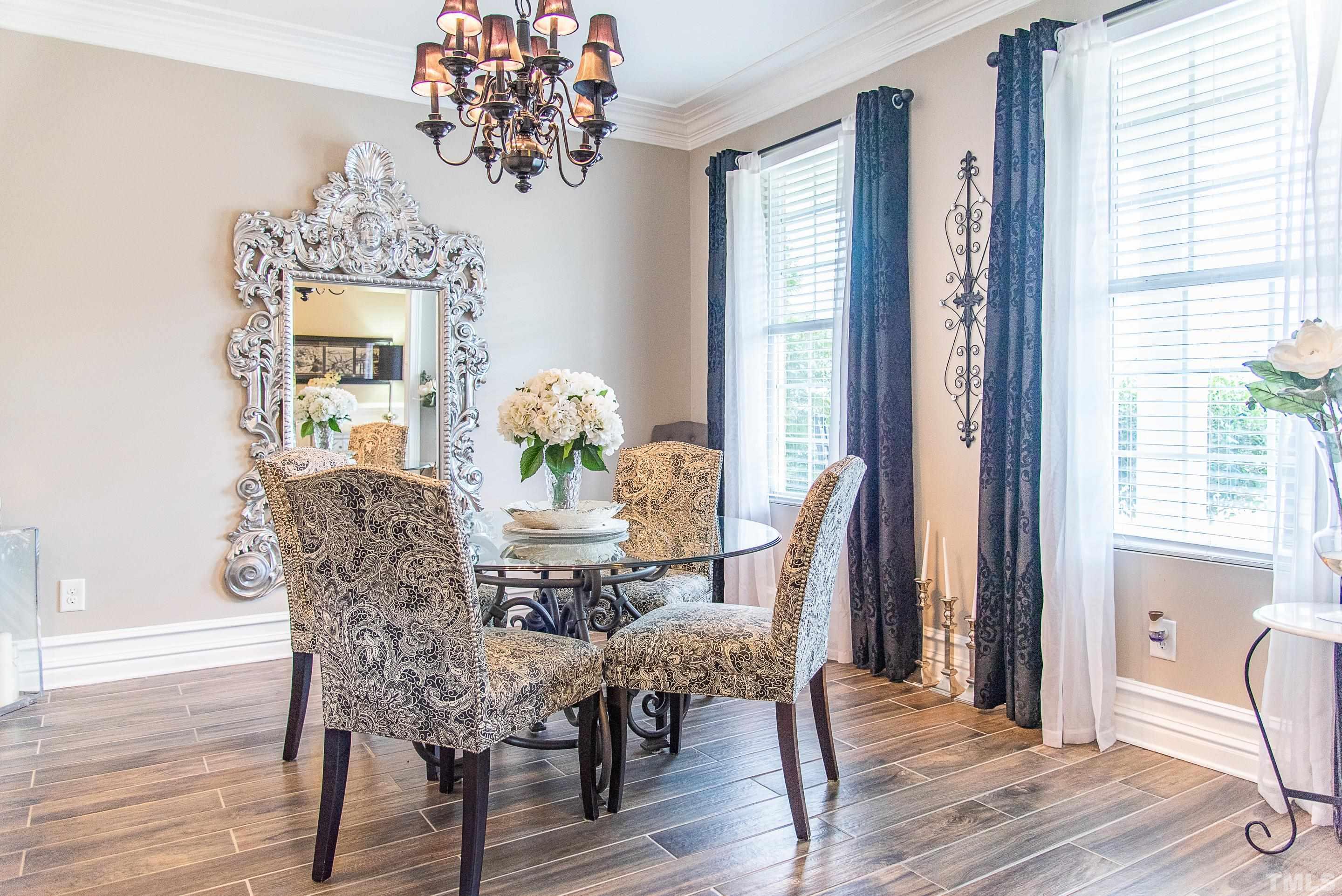 612 Hope Valley Road Knightdale, NC 27545 - Photo 37 of 56 a dining room with furniture wooden floor a chandelier and a mirror