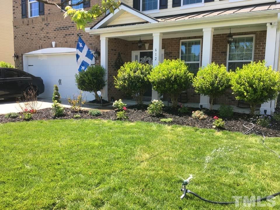 612 Hope Valley Road Knightdale, NC 27545 - Photo 5 of 56 a front view of a house with a yard and fountain