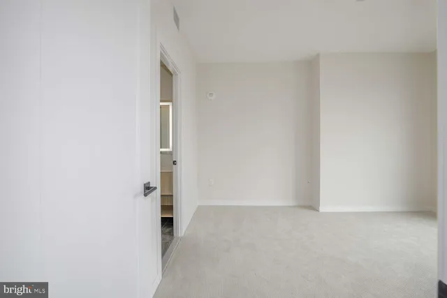 an empty room with large windows