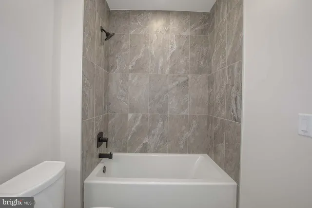 a bathroom with a sink mirror toilet and bathtub