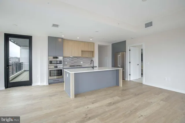 a kitchen with stainless steel appliances a refrigerator and a sink