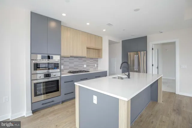 a kitchen with a sink a stove a refrigerator and a cabinets