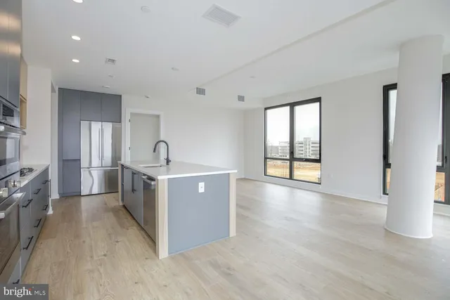 a view of a kitchen with a sink and a stove top oven