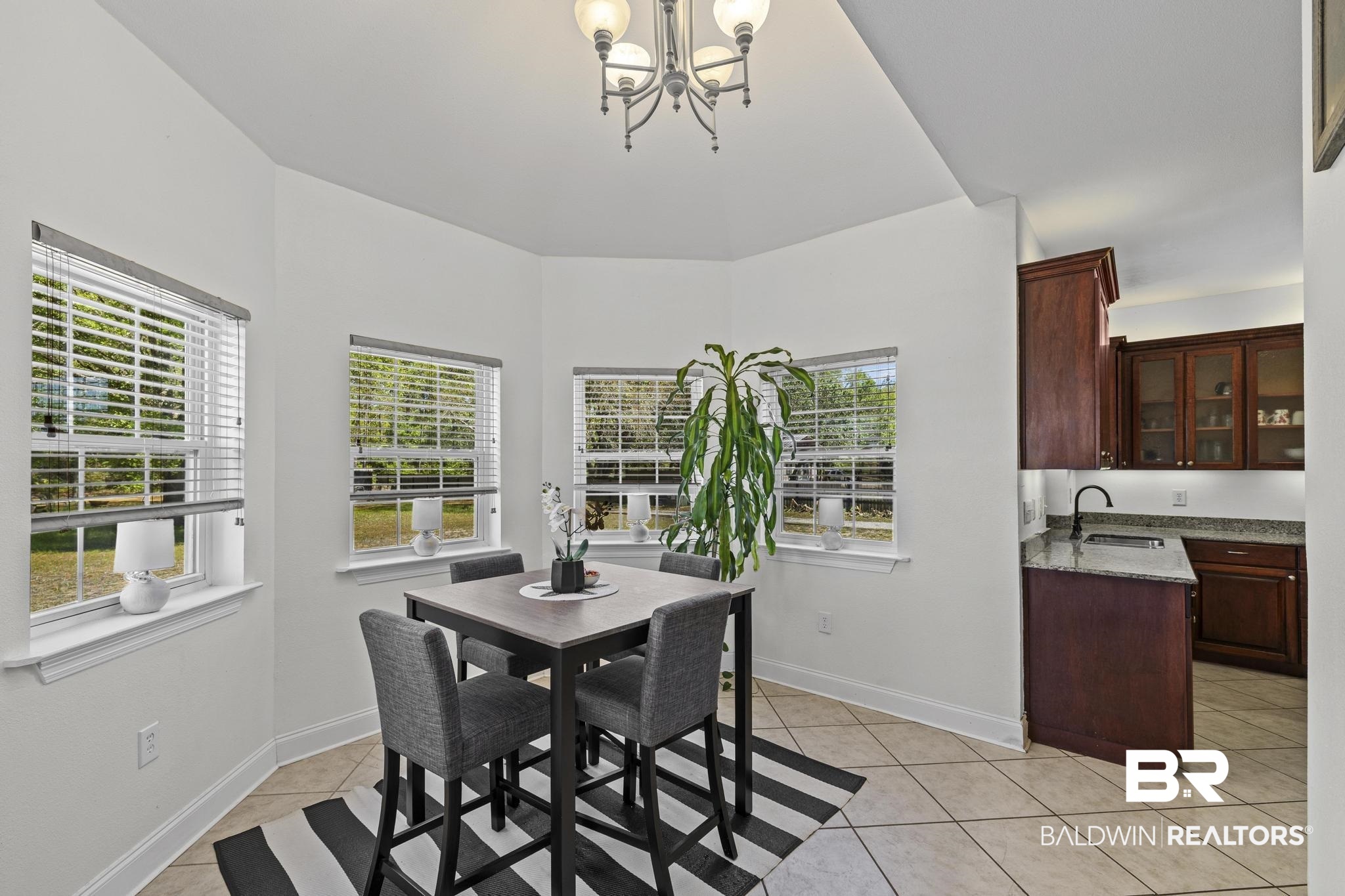 32875 Faircloth Road Lillian, AL 36549 - Photo 24 of 85 Dining space featuring light tile patterned floors and a chandelier
