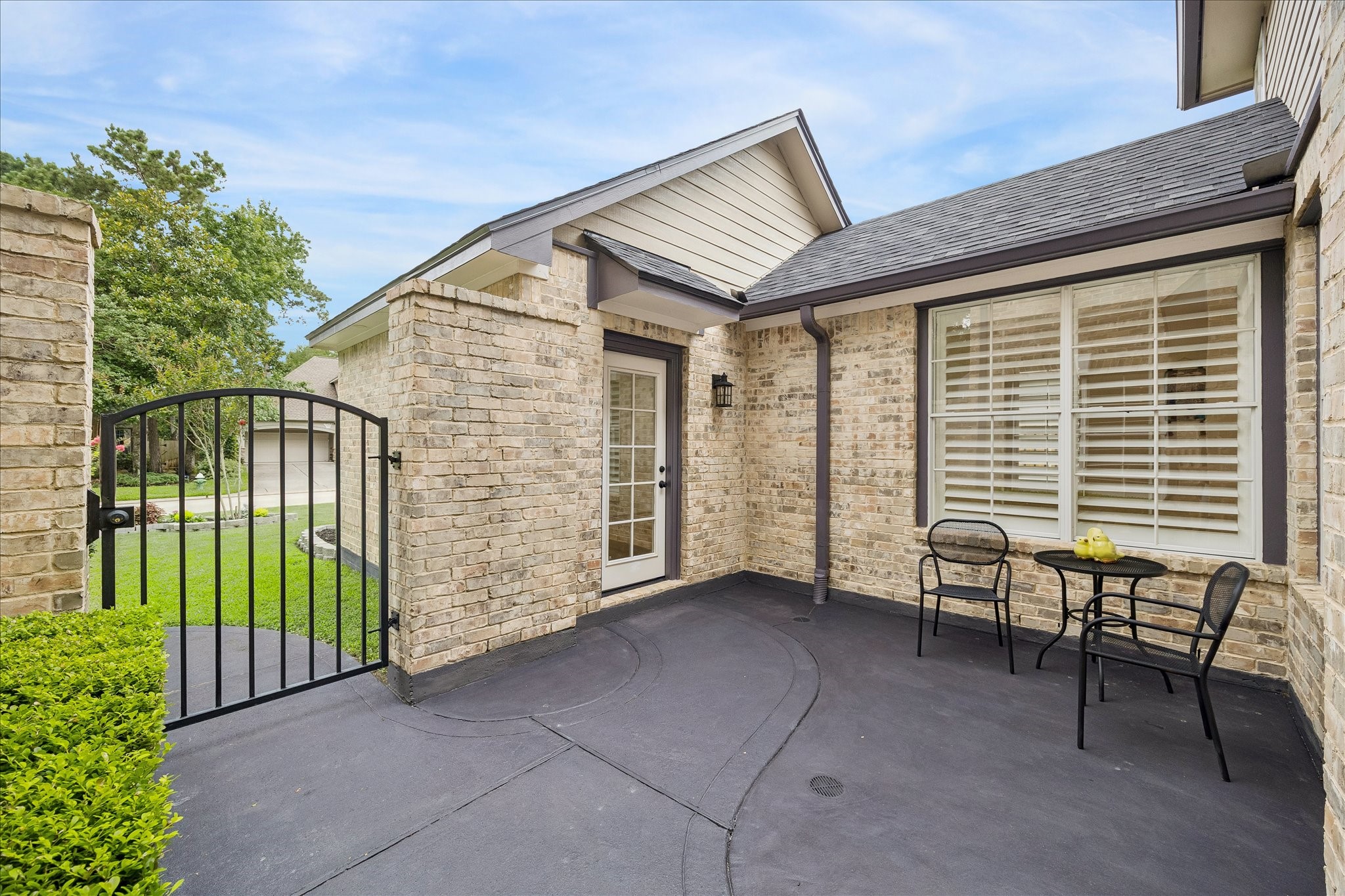 15 West Beckonvale Circle The Woodlands, TX 77382 - Photo 5 of 44 A glass French door provides private outdoor access to the attached guest suite, offering both convenience and a lovely architectural touch.