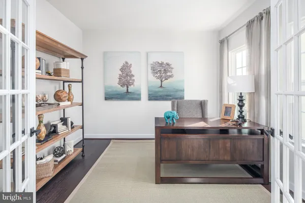 a living room with hard wood floors and a window