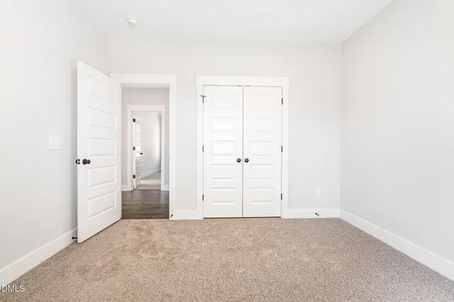 an empty room with closet area