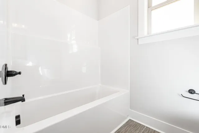 a white bath tub sitting next to a white sink