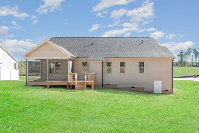 a backyard of a house with table and chairs