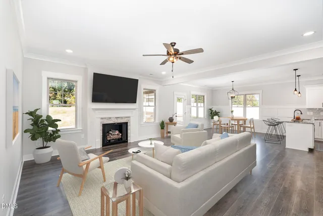 a living room with furniture a fireplace and a flat screen tv