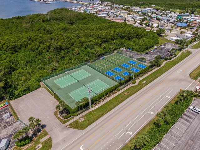 a view of a tennis ground with a large park