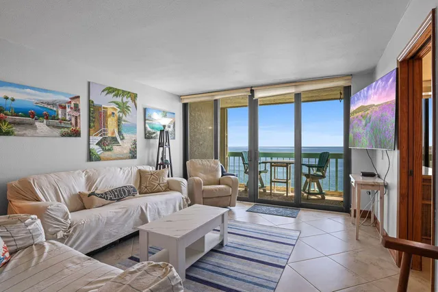 a living room with furniture and large windows