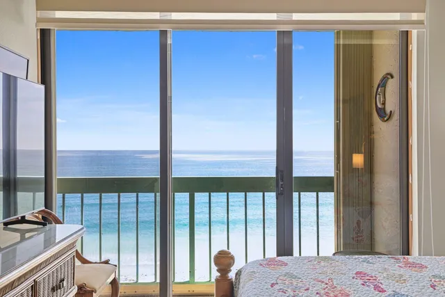 a bedroom with a bed and a large window